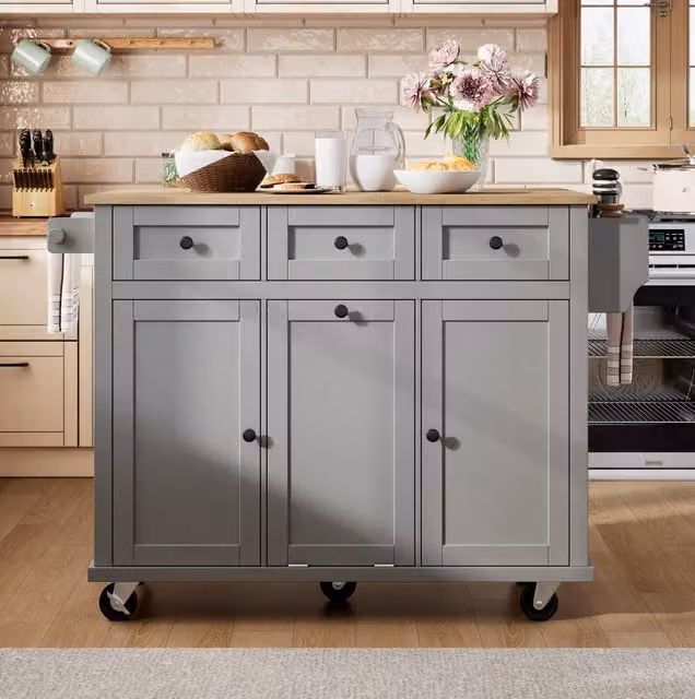 Isola da cucina mobile grigia con piano estraibile, cassetti e vano portarifiuti