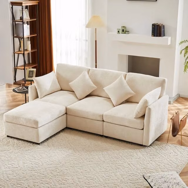 Divano angolare reversibile MIVRAY in tessuto beige con pouf e cuscini, ideale per soggiorno o ufficio