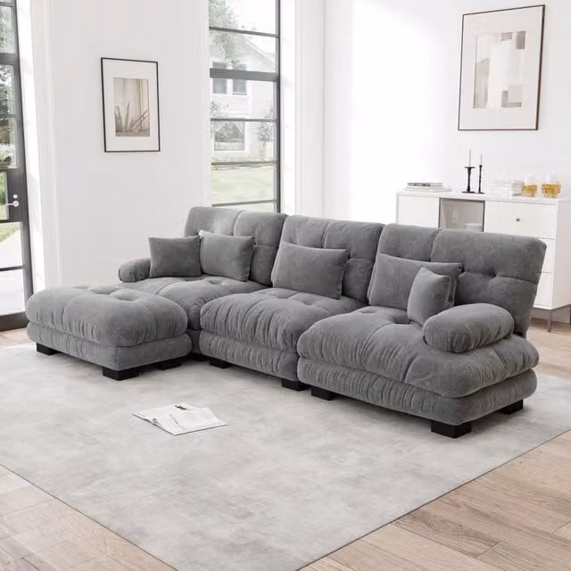Divano angolare modulare MIVRAY in tessuto grigio con ottomane mobili e cuscini coordinati, configurabile a L o a U