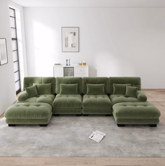 Divano modulare a U moderno in velluto verde con ottomano coordinato e cuscini inclusi