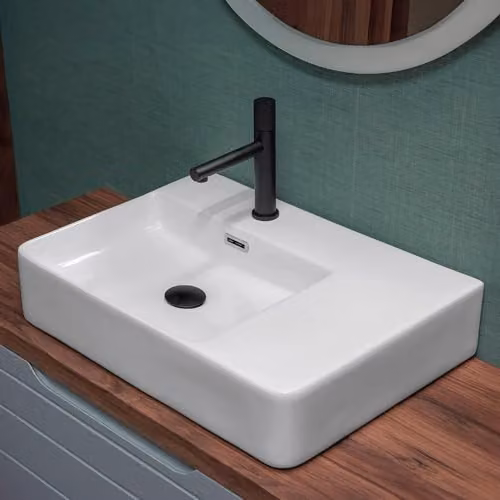 Lavabo da appoggio 60x43 rettangolare in ceramica lucida, vasca decentrata a sinistra e ripiano d’appoggio, forato per troppo pieno e rubinetteria