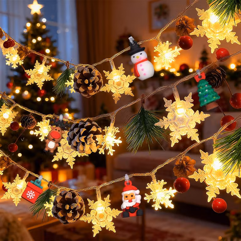 Catena luminosa da 2 metri, con 20 LED bianco caldo, decorata con fiocchi di neve e pigne