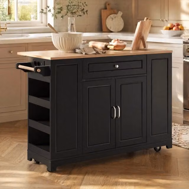 Isola cucina su ruote nera con piano estensibile, prese integrate e contenimento