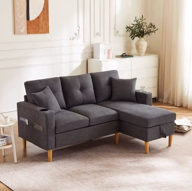 Divano angolare con chaise longue reversibile; contenitore; porta bicchieri e 2 cuscini; 175 cm; grigio scuro