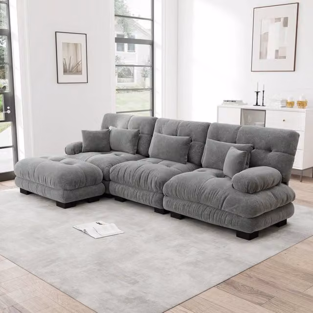 Divano angolare modulare MIVRAY in tessuto grigio con ottomane mobili e cuscini coordinati, configurabile a L o a U