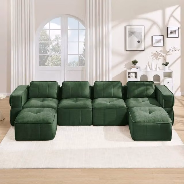 Divano modulare a L Minimal da 4 posti con 2 poggiapiedi coordinati in tessuto verde morbido